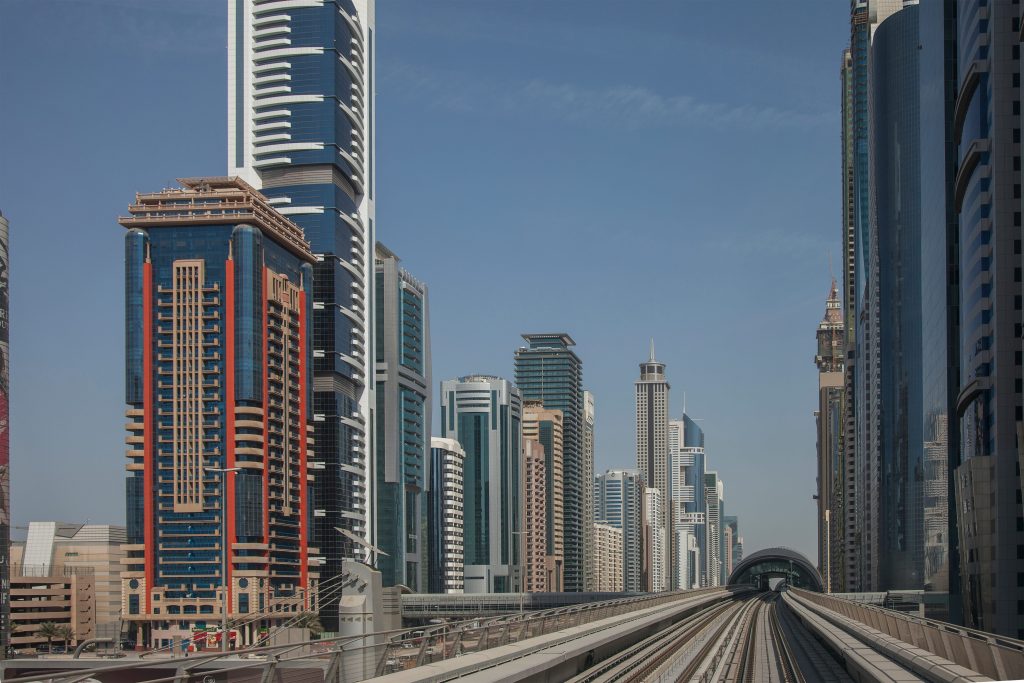 Dubai Metro tracks surrounded by skyscrapers in downtown Dubai
