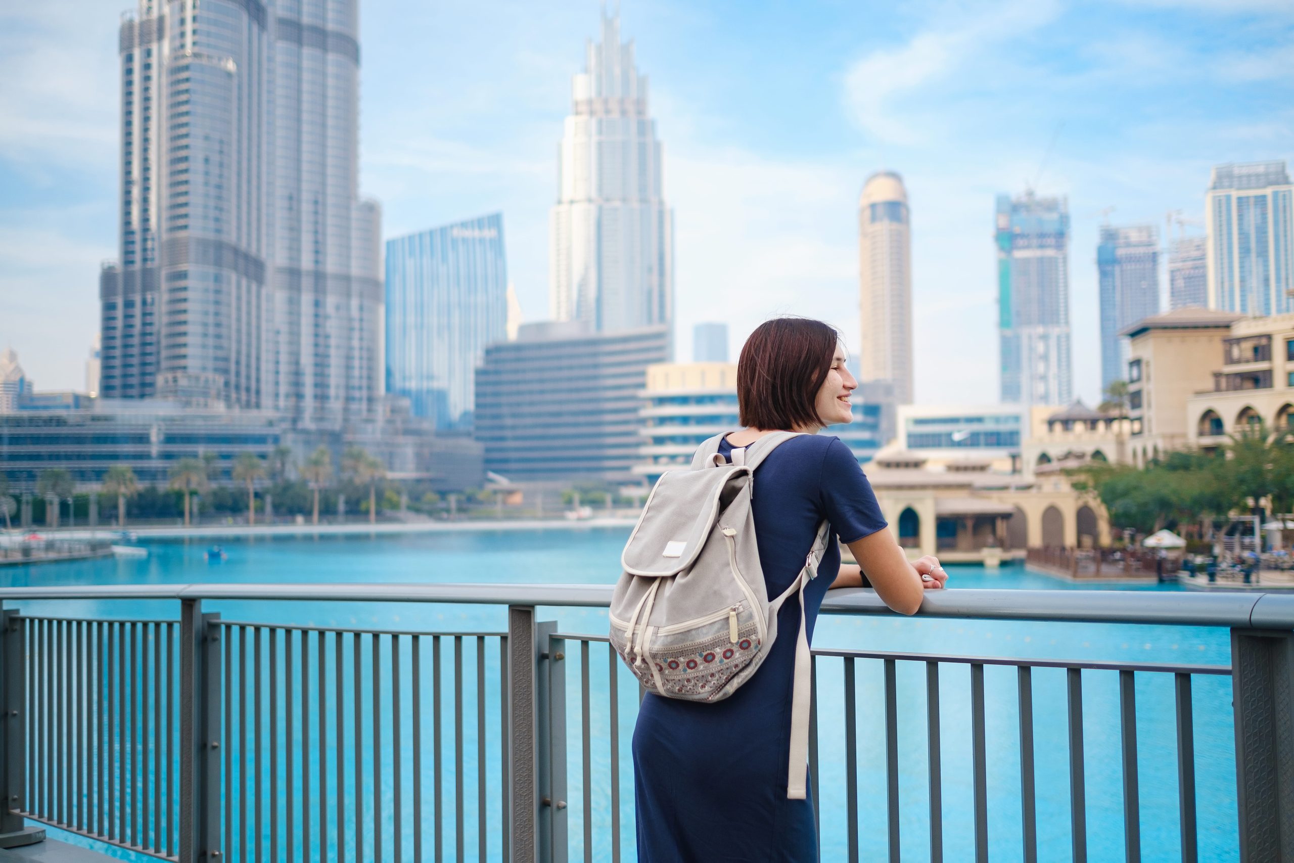 Traveller overlooking Dubai skyline and waterfront near Burj Khalifa